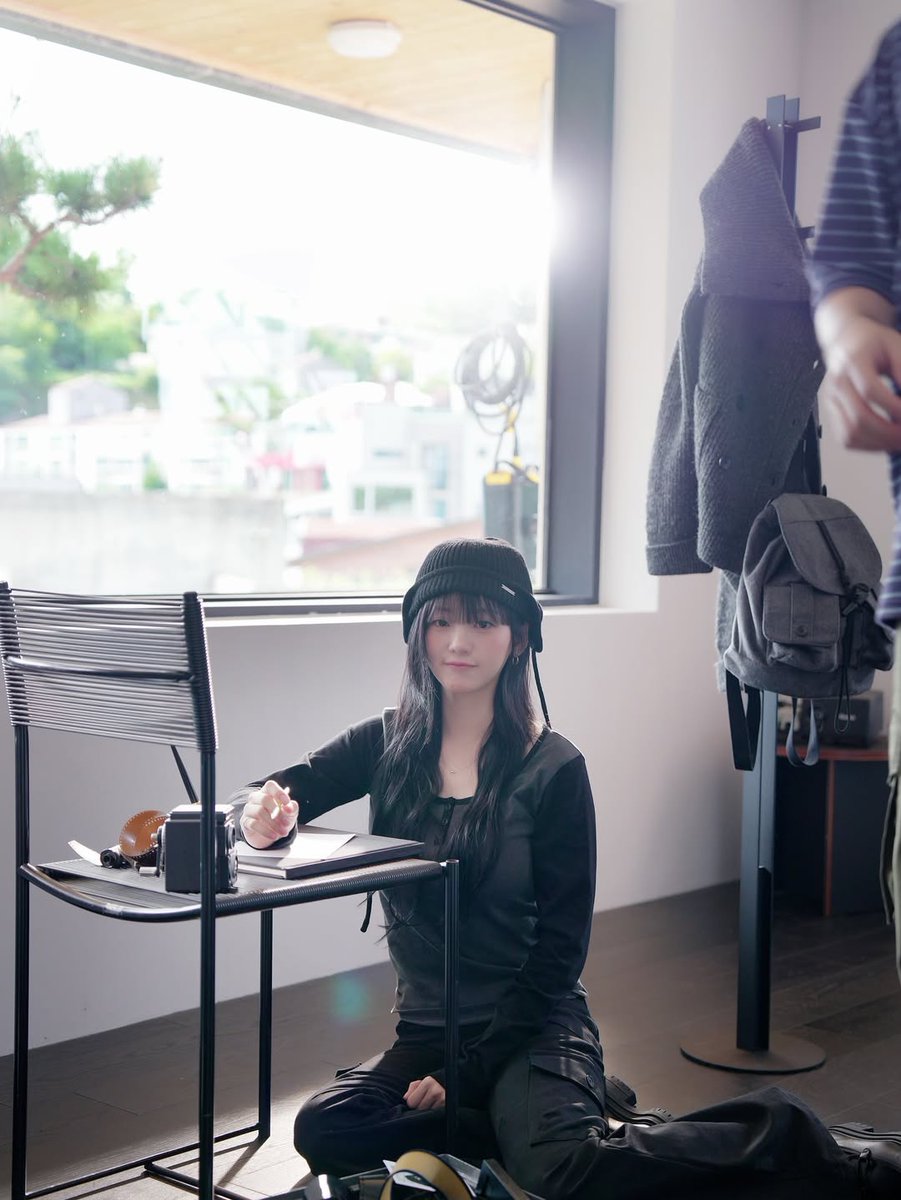 sunlight spilling through the window, quiet hands fixing tiny details, the whole room slowing down like a gentle scene from a late-nineties romance. warm air, soft hair, pages turning somewhere off-frame, and a moment that feels borrowed from a film reel.