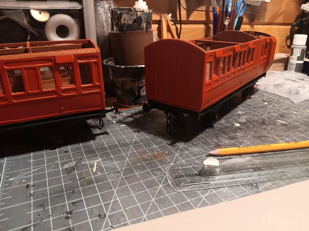 ModelsThomas's tweet image. Red branchline coaches on the workbench.