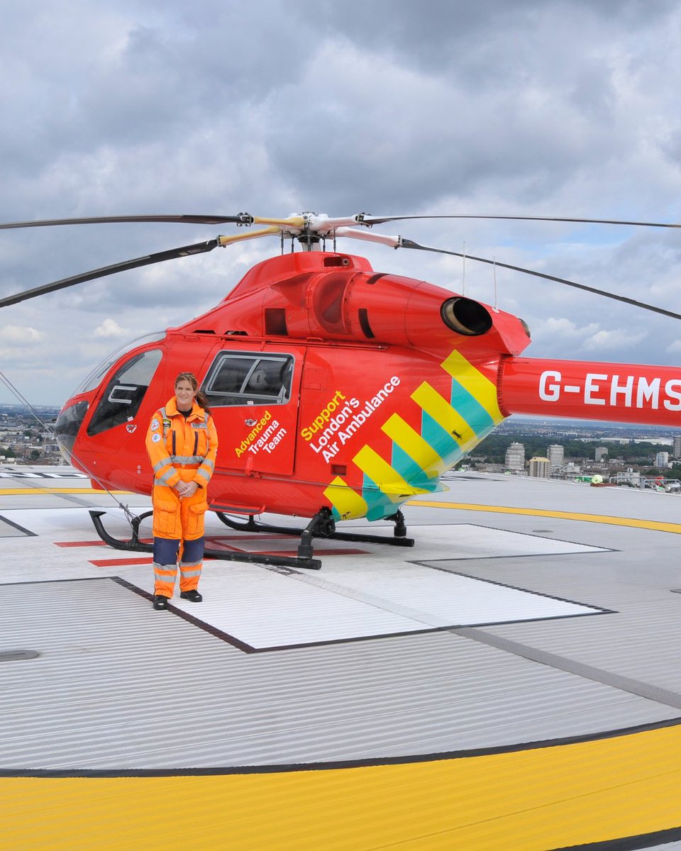 Anne standing in front of our helicopter, G-EHMS, on our helipad in central London