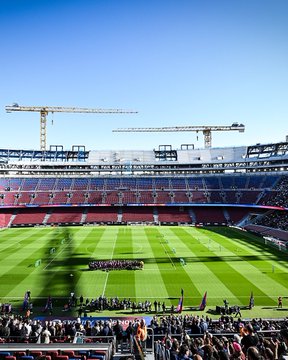 First image shows a young player with curly hair running on green soccer field during training, wearing pink sleeveless Barcelona jersey, blue shorts, pink armband, red and pink shoes, with agility ladders and cones nearby, stadium stands in background with FC Barcelona banner. Second image depicts FC Barcelona team in pink training kits posing together on field, stadium seating blue and red in background under construction cranes. Third image features Camp Nou stadium aerial view with green pitch, team in pink uniforms formed in circle center, surrounded by seated crowd in stands. Fourth image captures goalkeeper in pink and blue Barcelona kit with gloves walking on field, stadium crowd and banners visible.