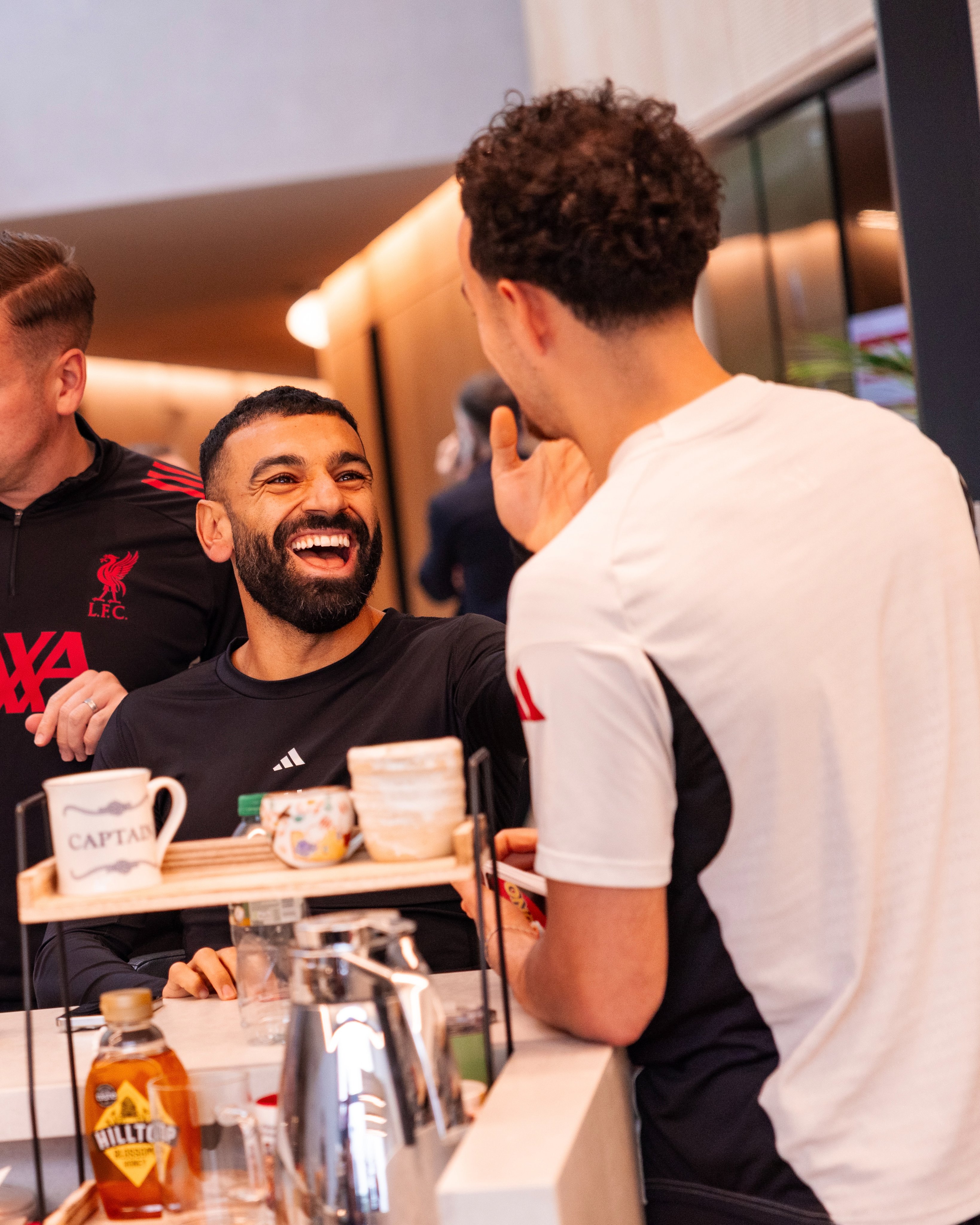 Photography of Mo Salah and Curtis Jones playing Uno.