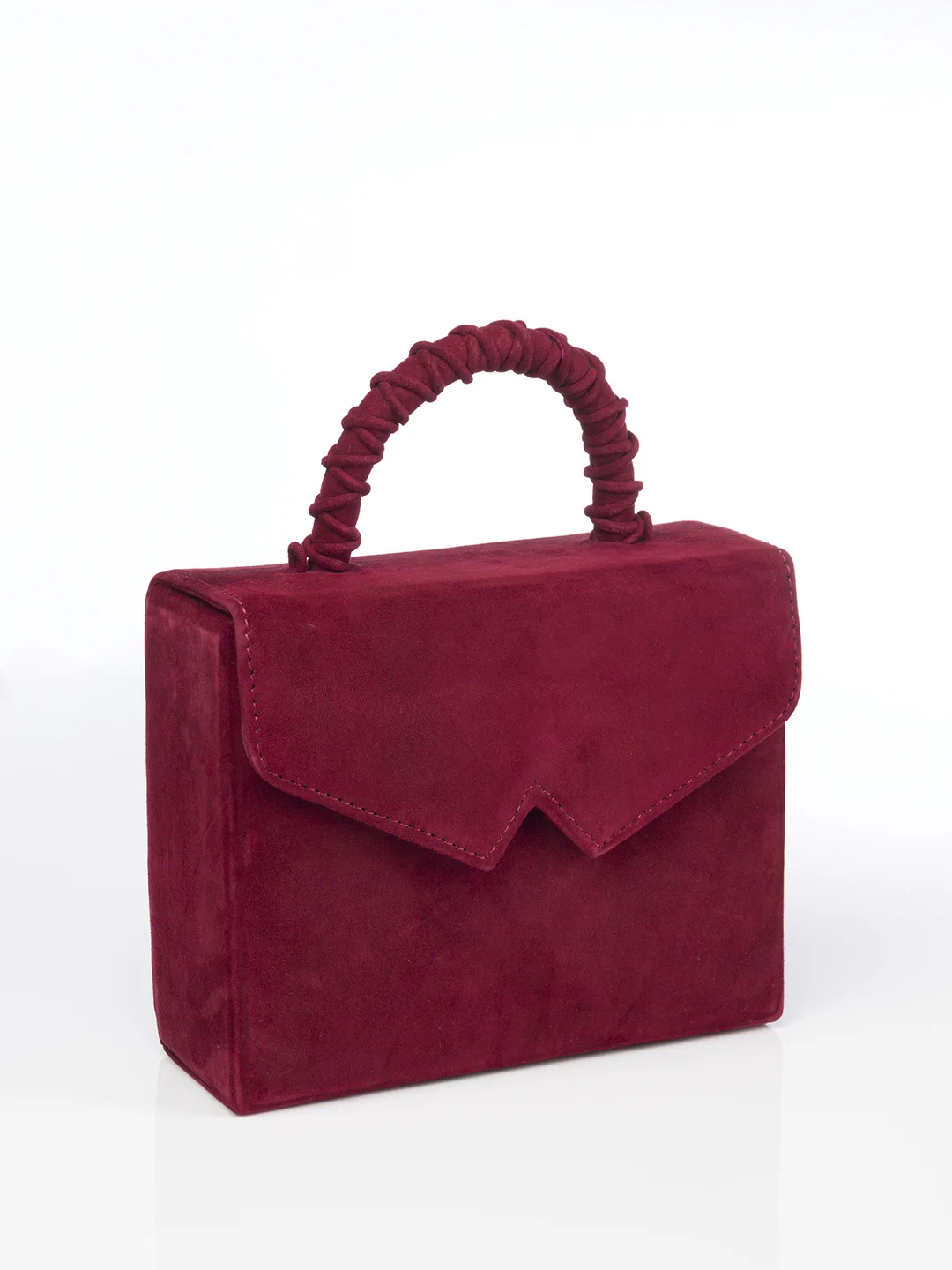A red handbag with a braided handle and a triangular flap closure, set against a white background.