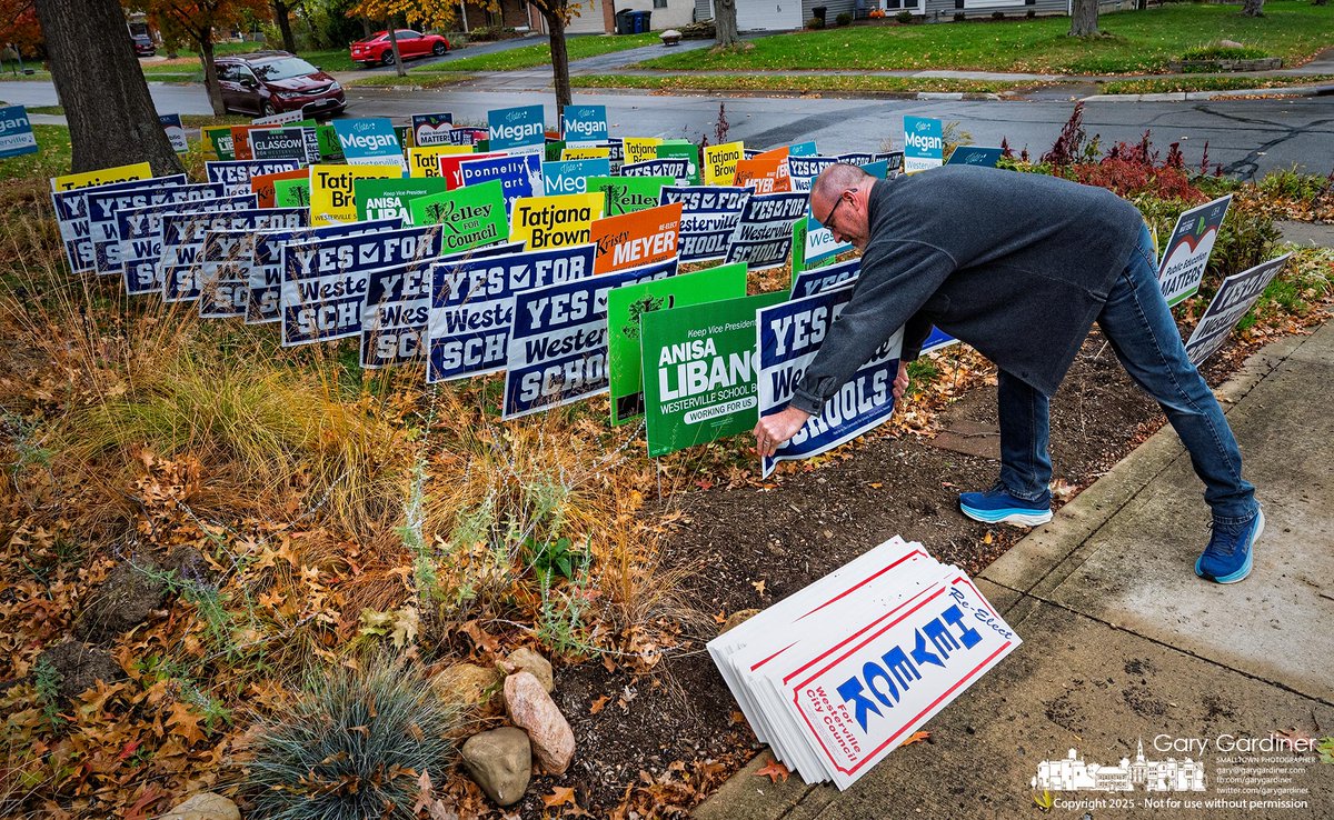 A voter adds a campaign sign to a collection of more than 400 gathered for recycling Saturday morning at a home in Annehurst. The signs will be taken to the City Service Department for processing. My Final Photo for November 7, 2025. rebrand.ly/mfp110725