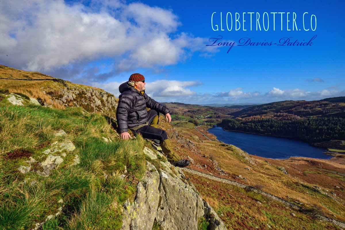 On TOP of the WORLD 🌍...
Life at 68 is a breeze! Have you ever faced the wind and let it blow your blues away? 🌬️ 
Taking a well-earned rest following a strenuous mountain climb 🏔️. Time to open a cold beer🍺 from the rucksack! 😉
GLOBETROTTER.Co 🌎