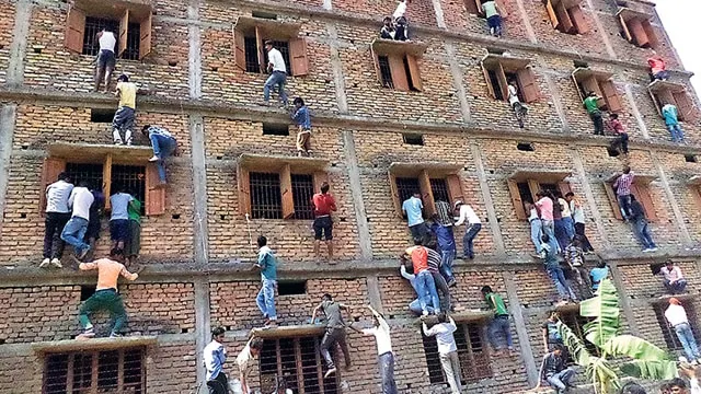 TimHowells_1000's tweet photo. @drtod1000 @War4theWest Here's how it works in India. Your relatives climb up the building to hand in the test answers through the window. Then they can qualify for their H1B visas! https://t.co/QZQQdox4gR