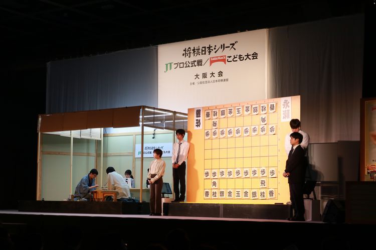 shogi_mobile's tweet photo. #ShogiLive 武蔵＠大阪＞第46回将棋日本シリーズＪＴプロ公式戦準決勝第２局（大阪大会）より、▲永瀬九段－△佐藤天九段の一戦を中継しています。戦型は相居飛車の力戦型。攻め合いの様相を呈した局面で封じ手に入りました。 https://t.co/RsipCkdZlO