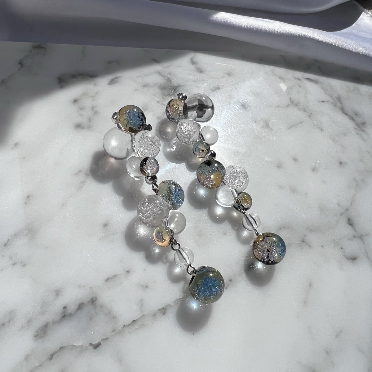 no19start's tweet photo. 無機質なfancyをコンセプトにアクセサリーを作ってます！
パール、シルバーやクリア系など透明感のある作品が多いです🫧

出展日：11/15,16両日
出展名：NO.19(ナンバーナインティーン)
ブース番号 ：南館4F P-370,371

#デザフェス62リポスト
#デザフェス62  #デザフェス62お品書き 
@designfesta https://t.co/HEJDR6jojm