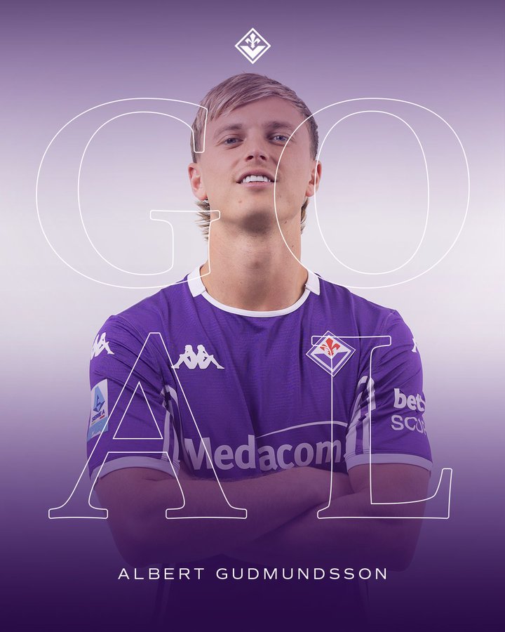 A young man with blonde hair wearing a purple ACF Fiorentina soccer jersey with number 11 on the front, arms crossed, smiling slightly, against a purple gradient background with the team logo at the top and text ALBERT GUDMUNDSSON at the bottom.
