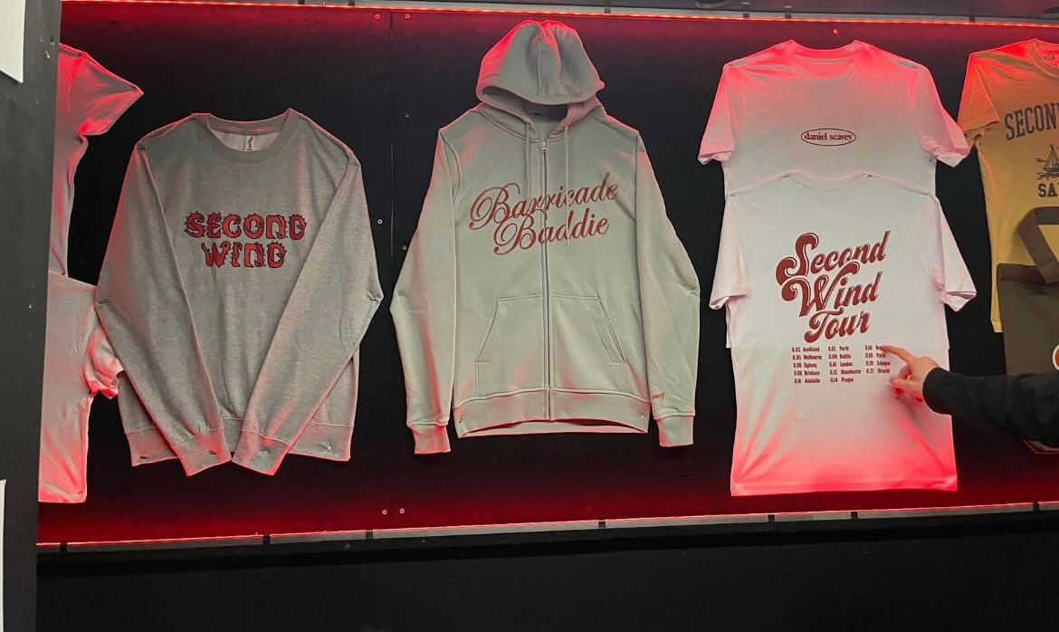 The new merch item for the Second Wind Tour is a zipup that says ‘Barricade Baddie’
