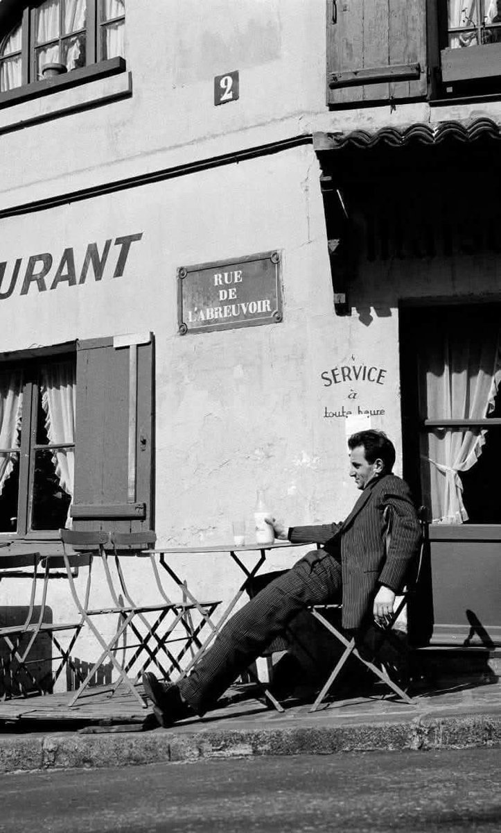Charles Aznavour en terrasse à la Maison Rose, Montmartre, Paris, 1955.