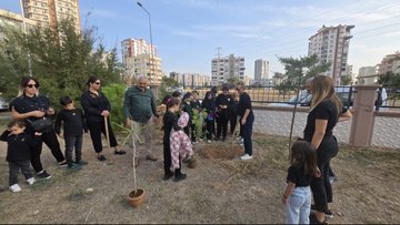 First image shows a graphic with Turkish text overlay on a background of a historical mausoleum building and a superimposed portrait of a man in a suit looking thoughtfully with a red rose emblem and school emblems at the bottom. Second image depicts a woman in dark clothing speaking into a microphone in front of an audience of women and girls in headscarves and uniforms seated in a conference room with red curtains and a projector screen. Third image captures a group of adults and young children in casual and traditional clothing gathered around a potted sapling tree in an outdoor urban area with apartment buildings and trees in the background planting the tree. Fourth image illustrates children and adults in school uniforms and casual attire kneeling in a circle around a newly planted small green sapling in soil outdoors near a fence with urban buildings visible engaging in the planting activity.