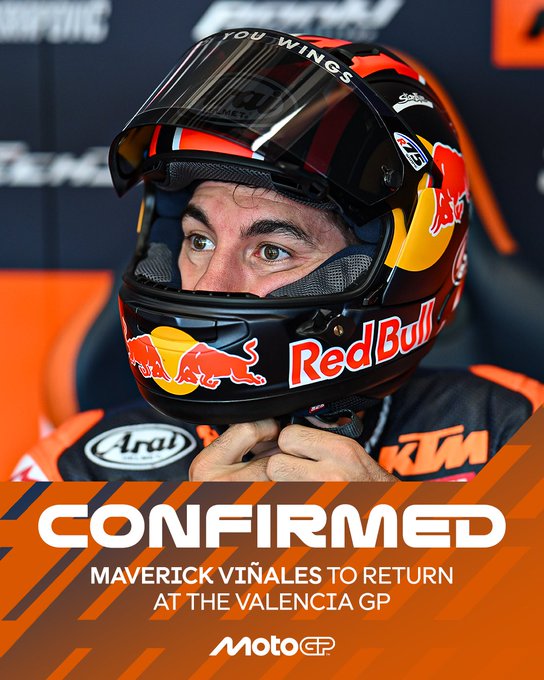 Maverick Vinales wears a black helmet with orange accents and Red Bull logos, positioned in front of a dark background with sponsor logos including You Wings and Aruba. He has short dark hair, a focused expression, and is dressed in a black racing suit with red and orange Red Bull KTM branding on the chest. The text overlay reads CONFIRMED Maverick Vinales to return at the Valenciagp MotoGP.