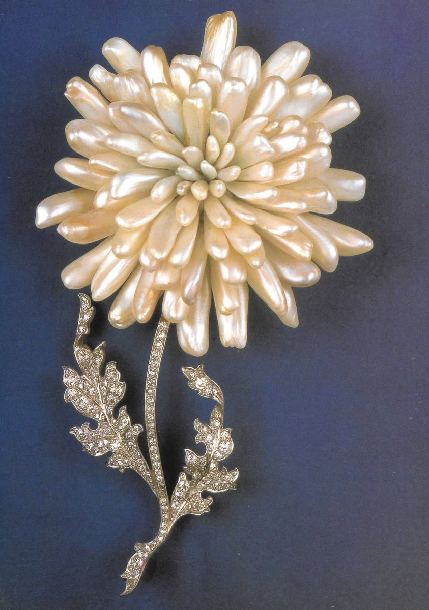 In 1904, G.Paulding Farnham a jewelry designer for Tiffany&amp;Co. created this very special chrysanthemum brooch... 

The stem and leaves, which are naturalistically rendered are pavé set with diamonds. The flower is created of Mississippi River pearls set in a gold supporting