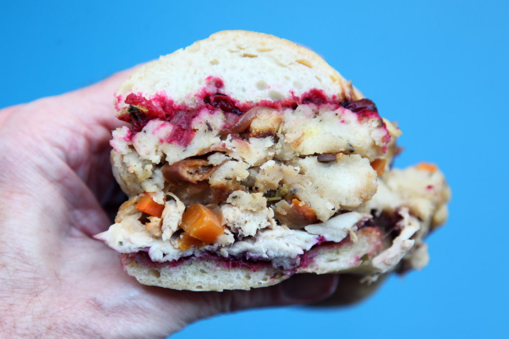 The Gobbler, a Thanksgiving-season sandwich dressed with mushroom stuffing and cranberry sauce on a garlic baguette, featuring not turkey but the chicken that you'd expect at a restaurant called Poulet Sans Tête, Amsterdam Ave., Manhattan