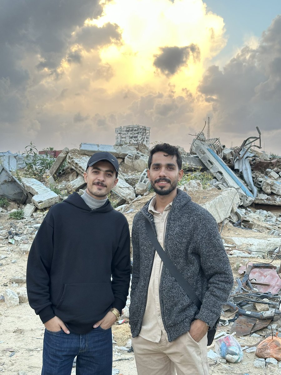 IamIbrahim21's tweet photo. In the heart of a broken road, in a displacement with no end, and a suffering that has become a lifetime of endurance, I keep searching for a modest apartment for my family in a city devastated by the brutal occupation—its features almost erased by the rubble, leaving behind nothing but costly ruins and wounded homes struggling to stand.

I left my family in the south, walking forward with tired steps, carrying a small hope: to return with a key in my hand, one that opens a door to life again, a door that takes us from the oppression of the tent to something that resembles home.

Alongside this struggle, my dear friend Omar and I continue searching for a safe corner where we can bring life back to the books we rescued from beneath the ruins. Each page that survived is a witness that knowledge cannot be bombed. We dream of founding the first community library in Gaza—a library born from agony, breathing from the ashes of rubble, preserving what remains of our words, and opening a window of light in a city that has not died, even if it has disappeared from the map.

With such companionship, exhausted dreams learn to walk on steady feet. And patience becomes lighter when it rests upon two hearts!

Here we remain. The dream endures.
Freedom is our appointment 🇵🇸
Stricken Gaza Strip — 11/2025