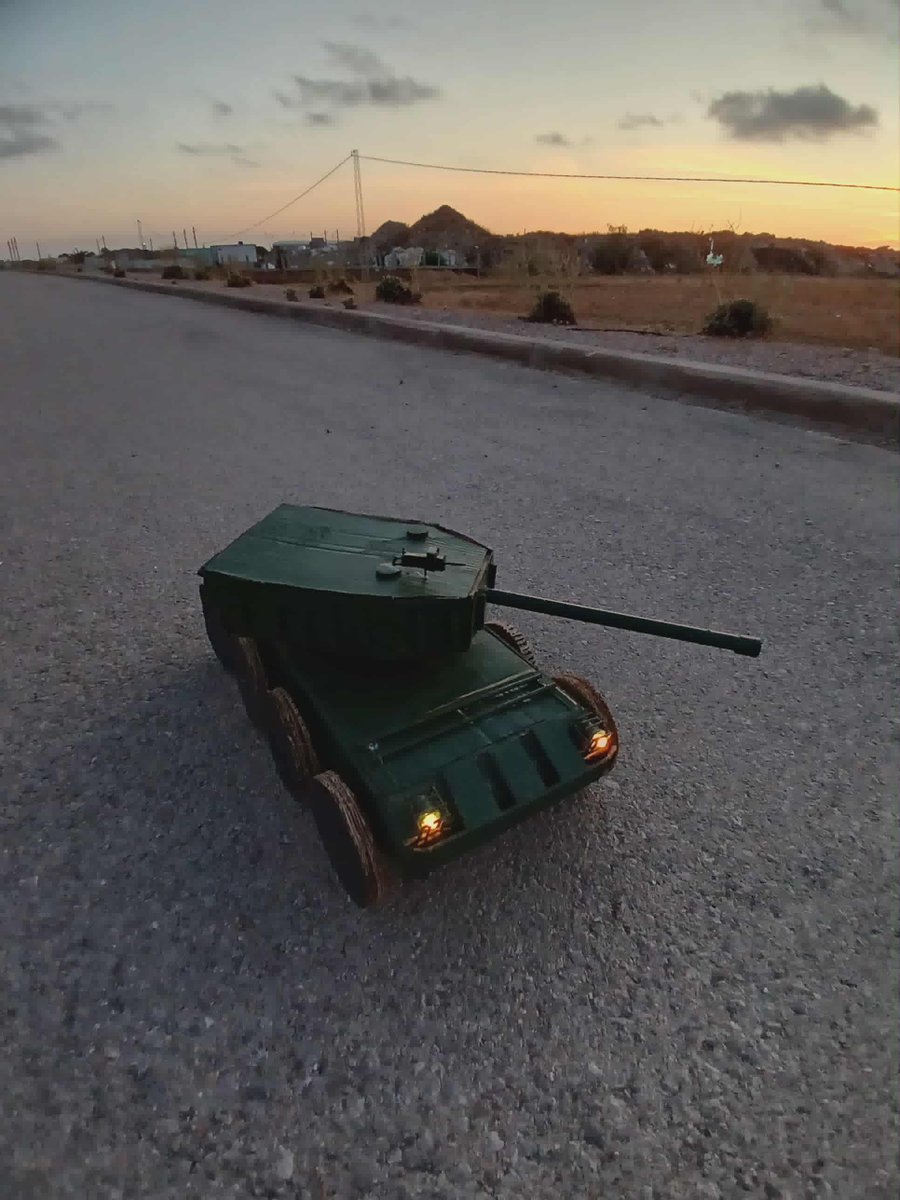 AzizHouidi's tweet photo. World, meet my tank-robot prototype, UGV concept:
 -designed &amp; built at home from wood, electric motors, and custom electronics 
 - Full movement, rotating turret 
 - adapted for reconnaissance, equipped with a cannon for necessary situations
 -inspired by Ukraine’s use of UGVs https://t.co/2E1eXtFaaM