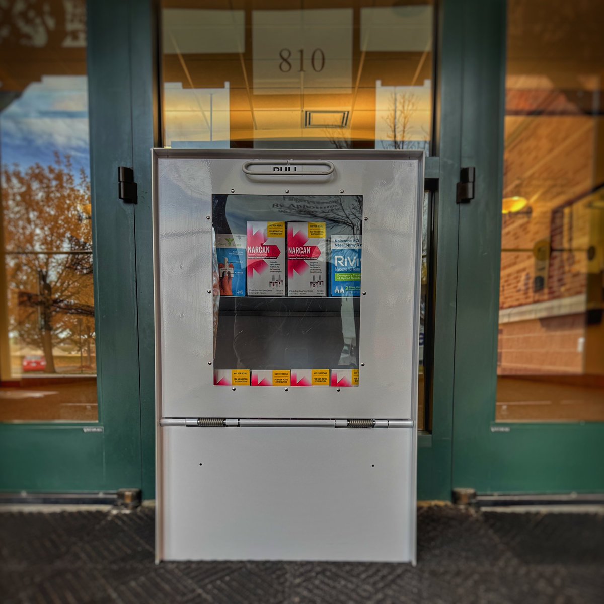 PoliceLoveland's tweet photo. Narcan Kiosk at Loveland Police Department 

Our lobby foyer—open 24 hours—now holds a Narcan (naloxone) kiosk. Pick up a kit at no cost, no questions. Narcan saves lives—simple truth.

First aid includes more than CPR and bandages. Sometimes help comes in a small spray bottle.

Access to tools like this often runs into cost or supply hurdles. Chief Doran, SummitStone Co-Responders, and detectives from our drug task force recognized a clear need and pushed forward for Loveland’s well-being.

Dangerous narcotics continue circulating across the U.S., including here. No one deserves loss due to addiction or accidental exposure. Fentanyl impacts more than those using drugs illegally; seniors juggling prescriptions and children getting into medication face risk too.

If one life remains with us because of this kiosk, the effort holds value beyond measure.

#JusticeKindnessHumility