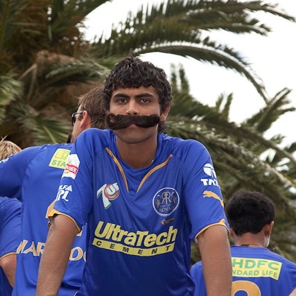 Ravindra Jadeja 
-  Started playing for a team that got banned after 8 years (RR)
- He himself got banned (2010 IPL)
- Played for a team which got immediately banned (Kochi Tuskers) 
- Played for another Team that got banned (CSK)
- Getting traded back to the team that got banned