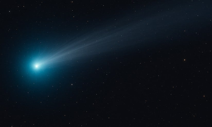 Bright cyan comet with a glowing head and extended tail streaks across a black space background filled with numerous small white stars.