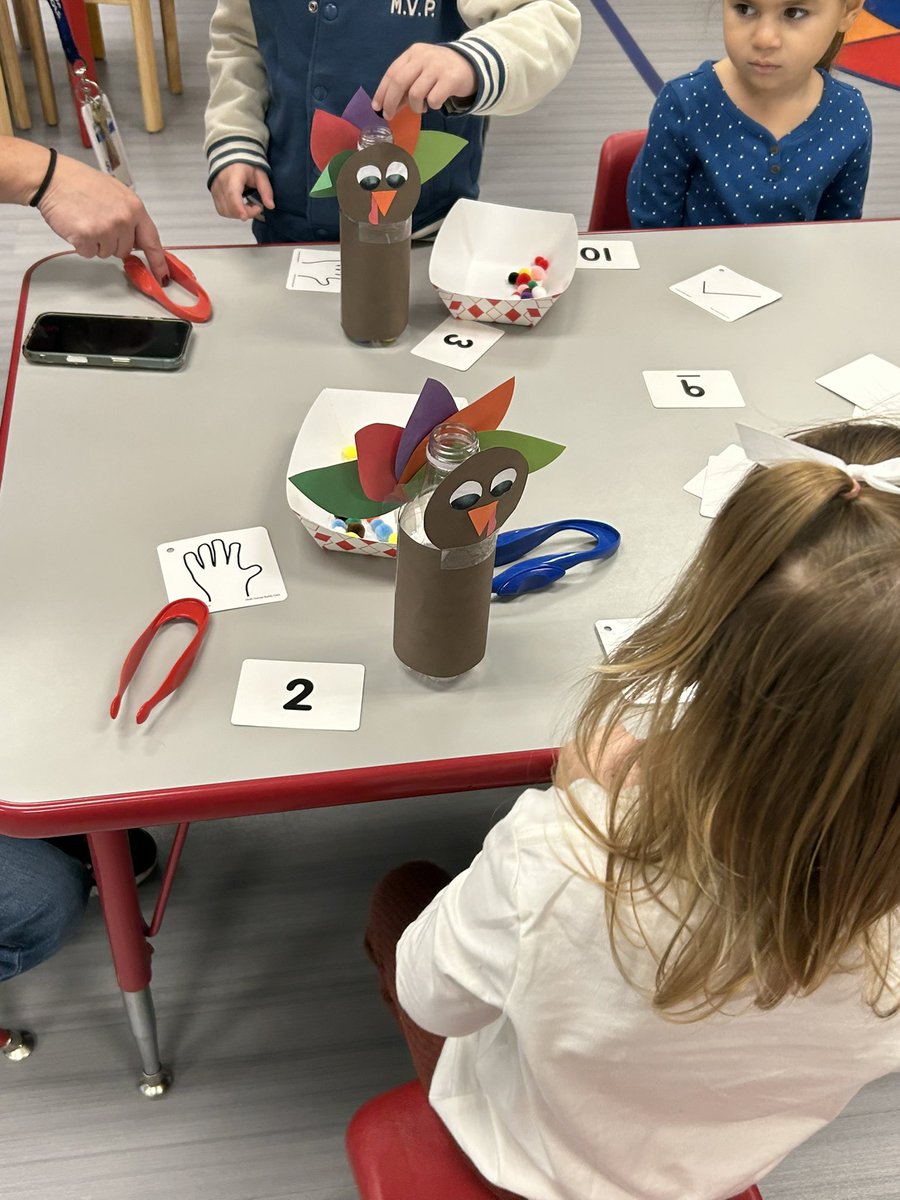 PB_Selover's tweet image. Ms. Susan’s class practiced counting and fine motor skills by using tweezers to “feed” a specific number of pom-poms to their water bottle turkeys!
