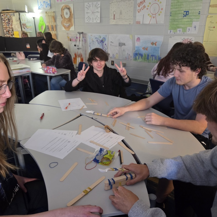Mrs. Painter's honors precalculus class created and designed marshmallow catapults to model quadratic projectile motion and determine maximum height, distance, and initial velocity.