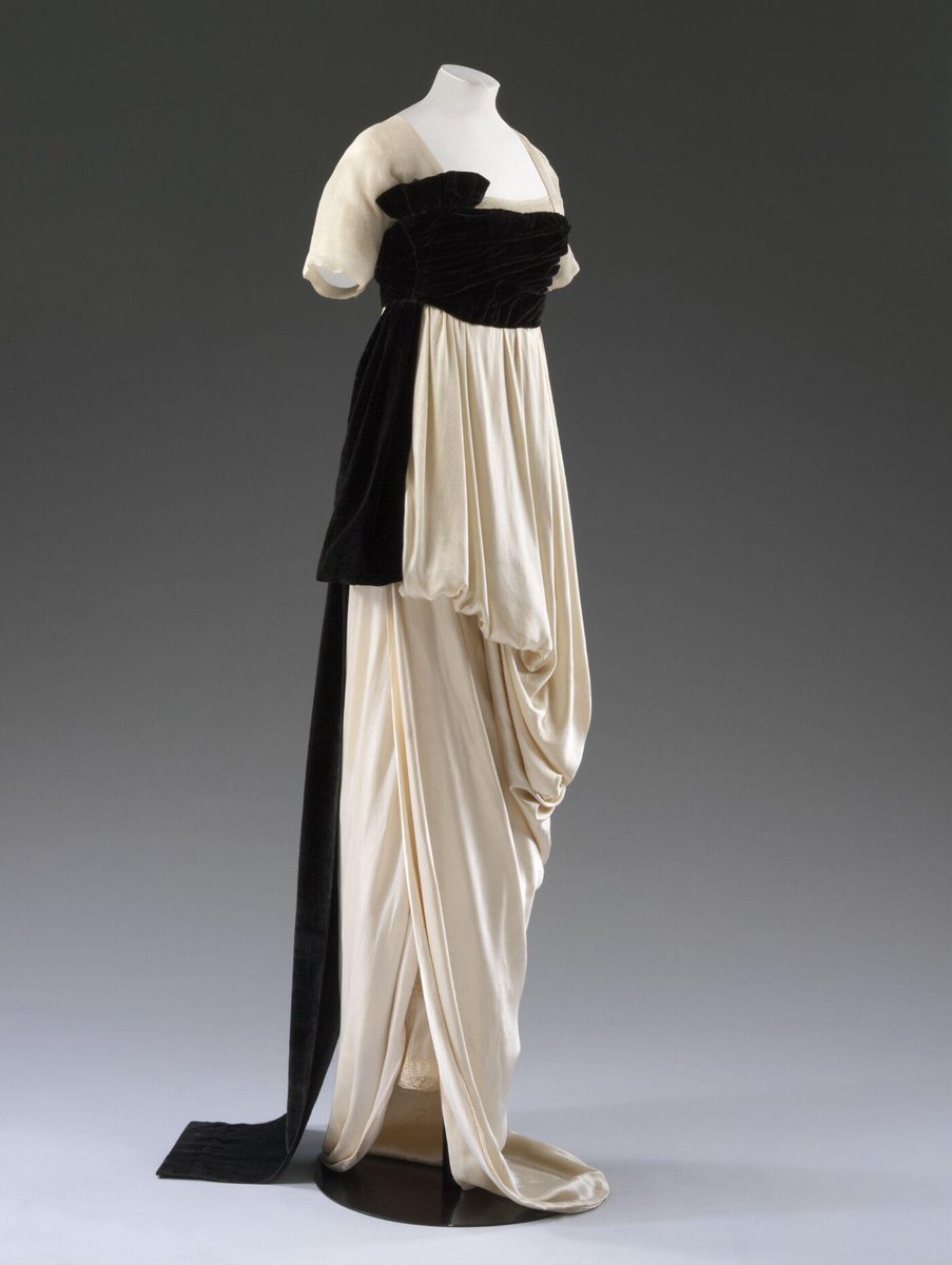 kateStrasdin's tweet photo. The cleverest designs are often those that look most effortless. This 1913 gown by Lucile and worn by Heather Firbank appears to be a twist of ivory silk caught in folds by a high sash of black velvet. Of course the reality is so much more complex @V_and_A #fashionhistory https://t.co/MjiyKy9AmN
