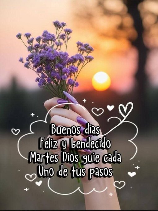 A hand with long purple-painted nails holds a bouquet of small purple flowers in the foreground. In the background, a vibrant orange sunset sky with the sun low on the horizon and silhouetted trees. Text overlays in white bubbles read Buenos dias, Felices y bendecido, and Martes Dios que cada uno de tus pasos, with heart emojis.