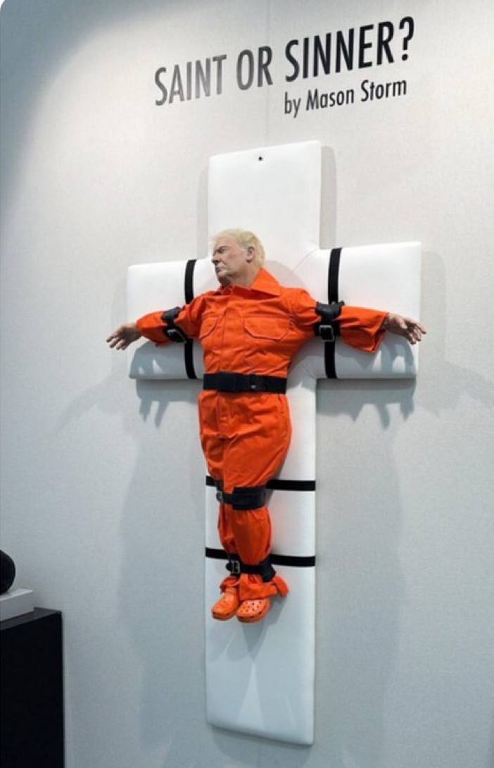 Very disturbing…

British Artist Mason Storm crated a life-size Trump sculpture depicting President Trump nailed to cross Crucified in Orange Jumpsuit

Titled “Saint or Sinner,” this “work of art” was installed near a historic church, described to probes religion vs. politics.