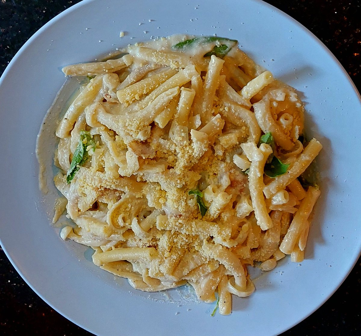 Early lunch today was put together from last night's different kids meals.
Carbonara pasta with chicken and shimeji mushrooms with garlic. 
I just mixed them together with a few thai sweet basil leaves, 
warmed up and sprinkled lots of parmesan cheese on top.
Very lovely 🤌😋
