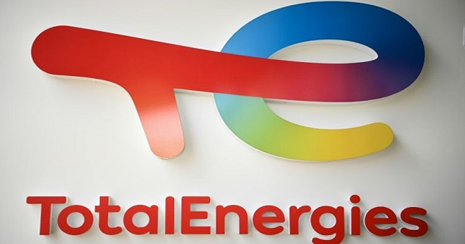 Red T-shaped element connected to blue E on white wall with multicolored gradient below and red TotalEnergies text underneath