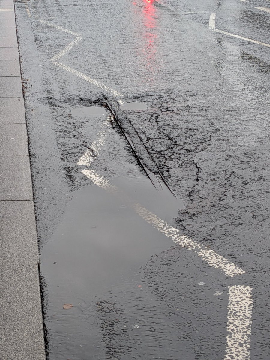 thomasforth's tweet image. Rain makes visible a lovely example of why buses, especially British double decker buses, need so much more operating subsidy than good rail-based transit. The bus grooves ground into the road throughout Leeds reveal the old iron tram lines which they cannot grind through.