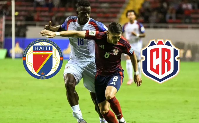 Two soccer players in action on a green field during a match, one from Haiti in a white jersey with number 10 dribbling the ball, pursued by a Costa Rican player in a maroon jersey with number 6, stadium seating and flags of Haiti and Costa Rica visible in the background, team logos displayed at the bottom.