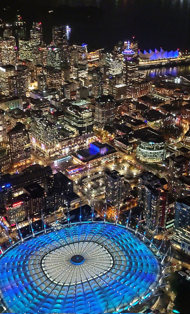 TrishJewison's tweet image. Rainy night flight over downtown #Vancouver 💜💙💚