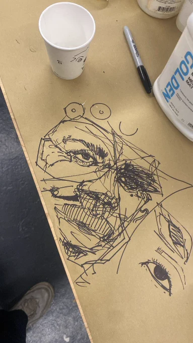 Me drawing random black faces whenever i see a sharpie laying around and a clear surface