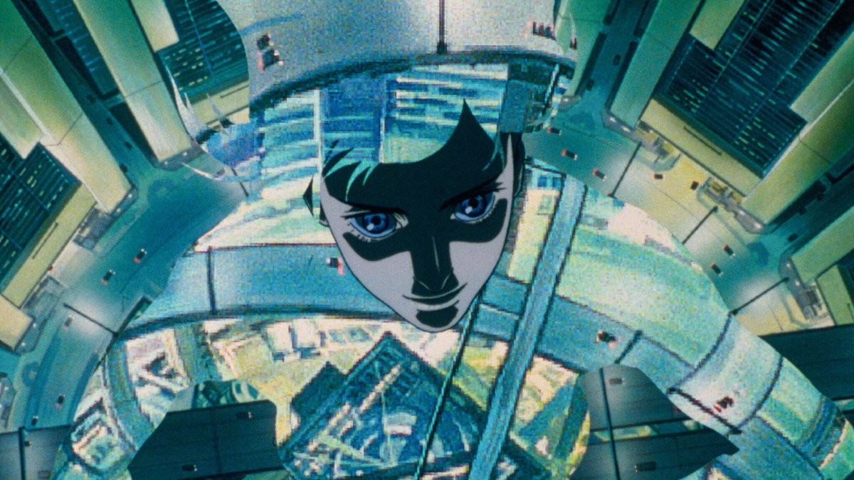 The memorable opening rooftop scene of Major Kusanagi Motoko, with the bustling cityscape of New Port City in the background, in the 1995 classic Ghost in the Shell.