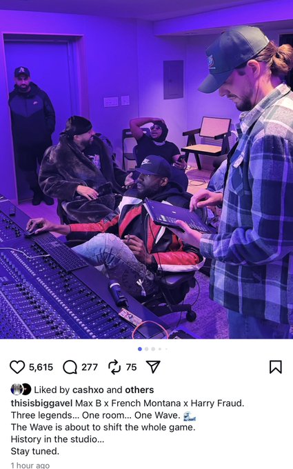 Dimly lit recording studio with purple ambient lighting features hip-hop artists Max B, French Montana, and Harry Fraud positioned around a mixing board and equipment. Max B sits on the left wearing a red jacket and jeans, focused on the board. French Montana stands in the center in a green hat, plaid shirt, and jeans, gesturing. Harry Fraud is on the right in a black cap and gray hoodie, leaning in. Additional musicians in hats and jackets sit and stand nearby on chairs, observing the session.
