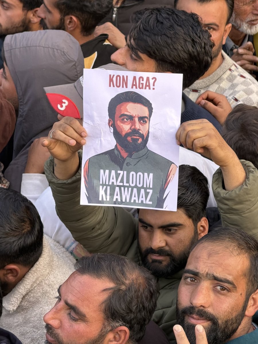 Supporters of Aga Ruhullah show his posters after PDP won the Budgam assembly seat.
