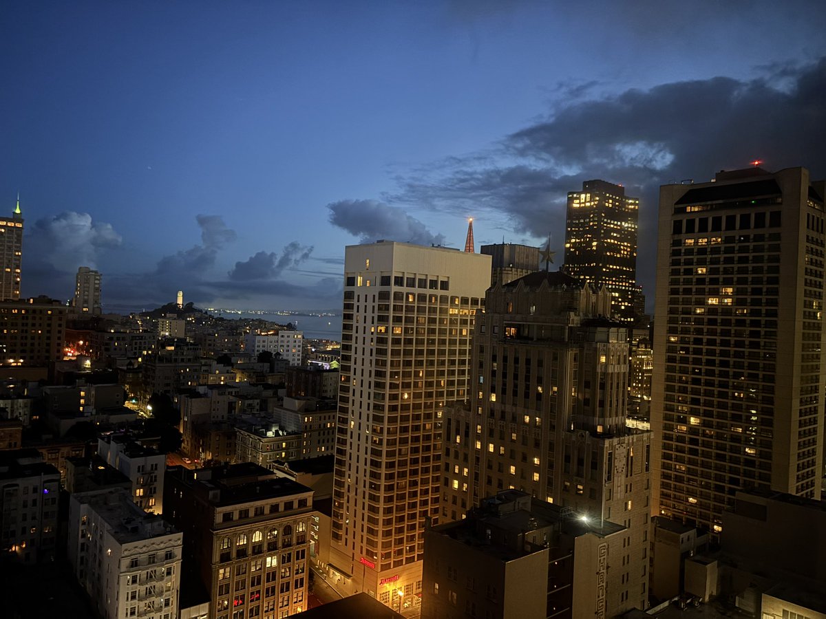 AndrewAbranches's tweet image. When day withdraws its golden, lingering hand  
And dusk ascends behind the urban frame,  
A hush prevails across this storied land;  
The city’s pulse is softened, never tame.
From high-rise windows, squares of light appear,  
Each one a hearth—unseen, yet warm and real—  
And…