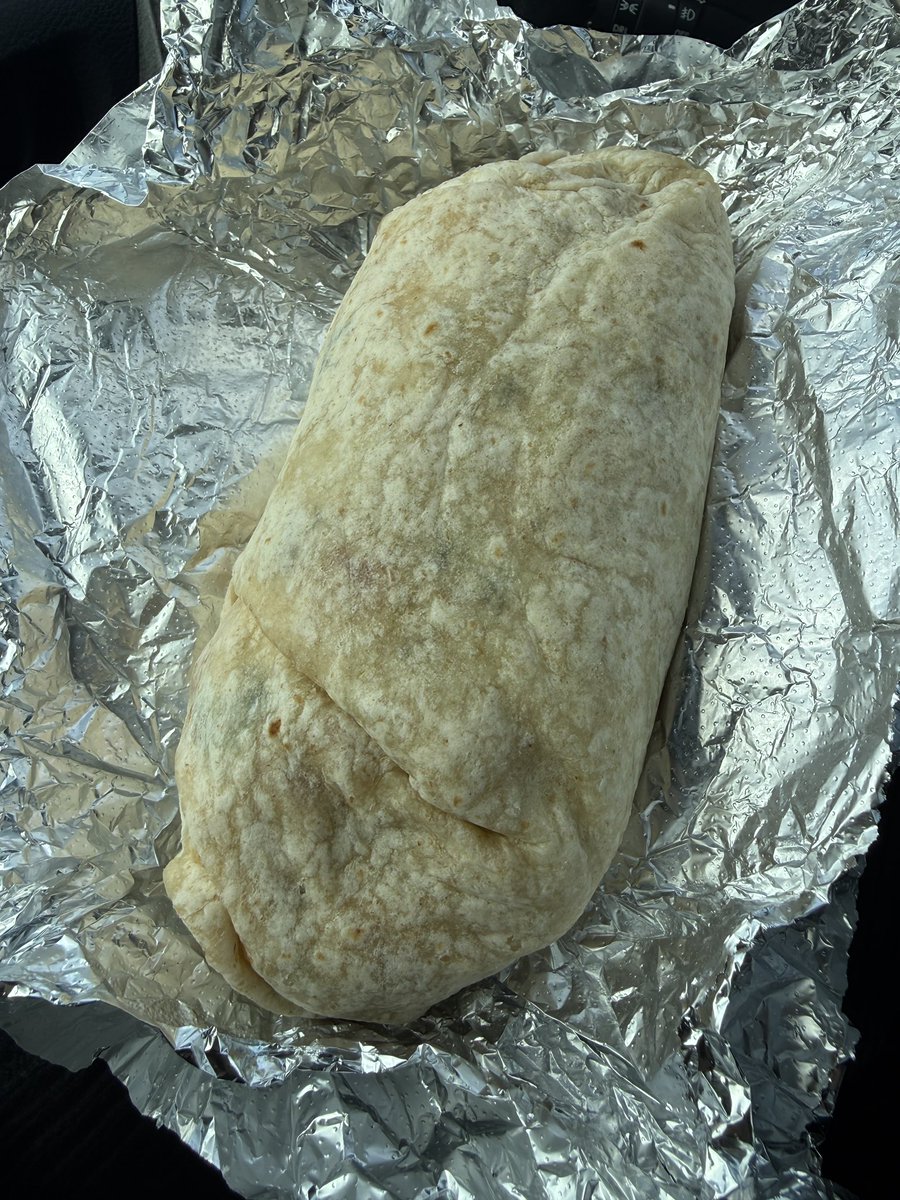 this burrito stretches from the tip of my finger to the middle of my fucking forearm. this thing is absolutely insane are you kidding me 😂
