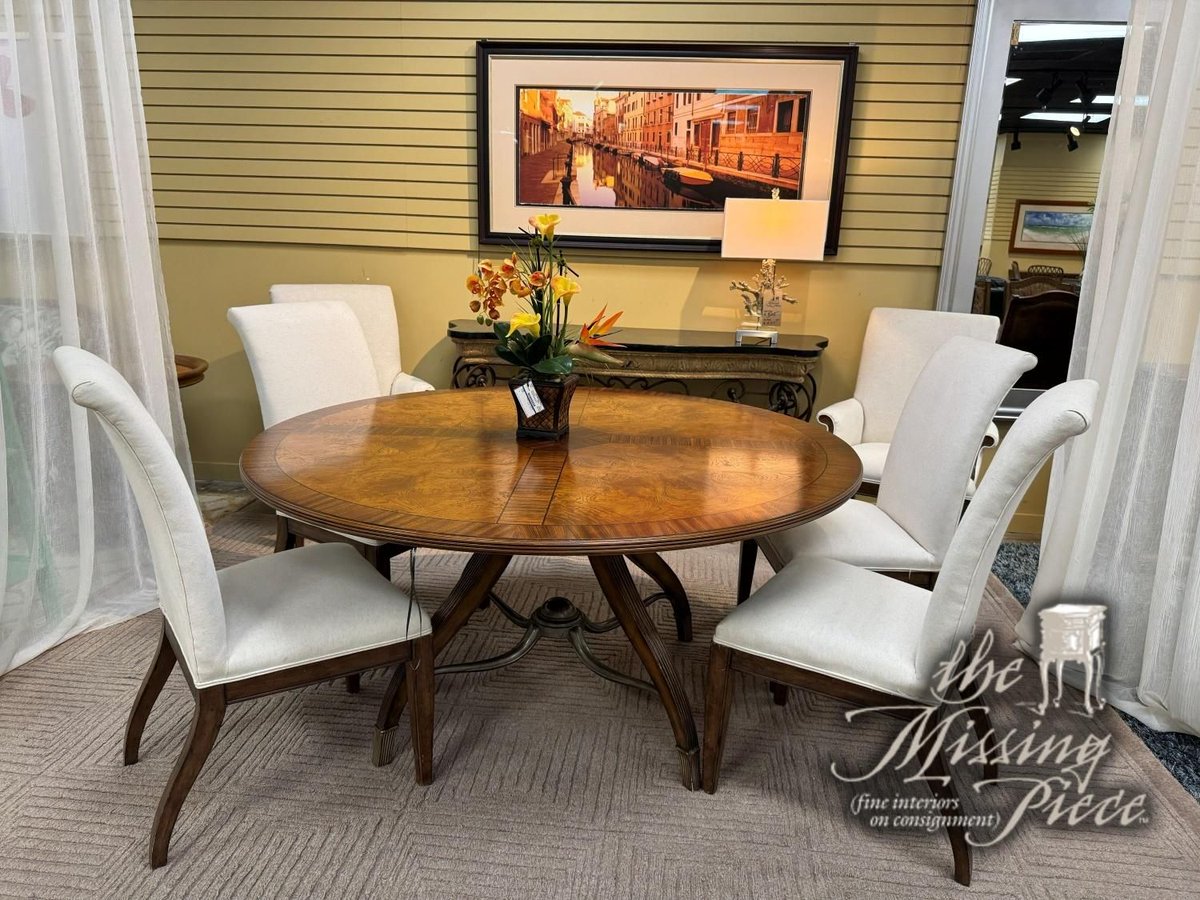 Traditional style inlaid wood dining table in a dark finish with six dining chairs. The chairs are done in a white upholstery on dark wood legs. Measures 63"round. 
Click here for pricing and availability ➡ buff.ly/dq3ssVw
