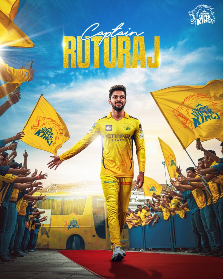 Ruturaj Gaikwad stands in a yellow Chennai Super Kings jersey and pants, walking on a red carpet toward the camera with arms outstretched, surrounded by blurred fans in yellow waving team flags on both sides, under a bright blue sky with yellow text overlay Captain Ruturaj and the team lion logo in the top corner.