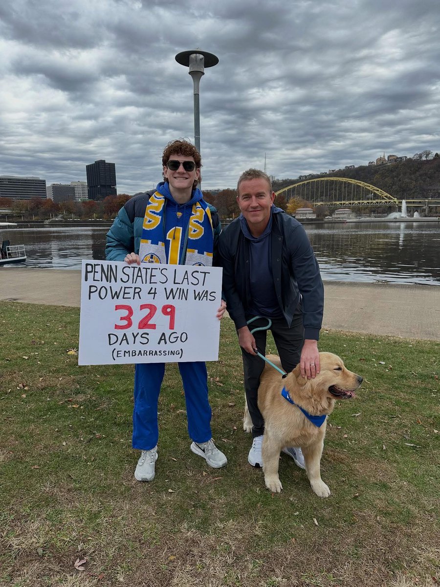 ThePoniExpress's tweet image. Pitt fan’s College Gameday sign CRUSHES PENN STATE. And he got a picture with Herby and his dog 😂😅