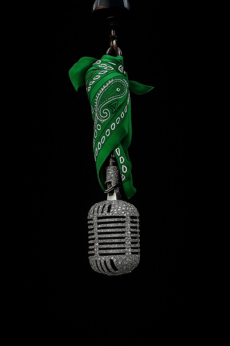 Dropping bars with the mic in hand, green bandana locked in.