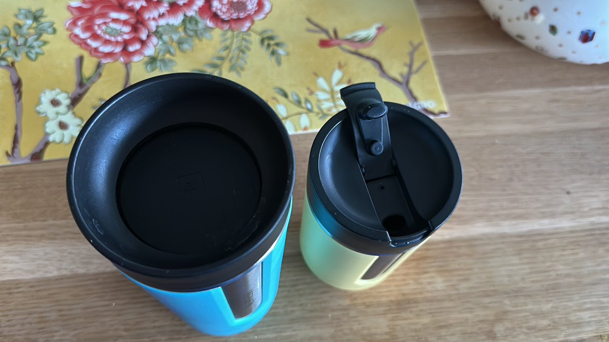 kanav's tweet photo. Nespresso you ruined the travel mug design. Old style left = perfect. Right side new cup = worst for hot drinks on the go. https://t.co/SKMa1Qetth
