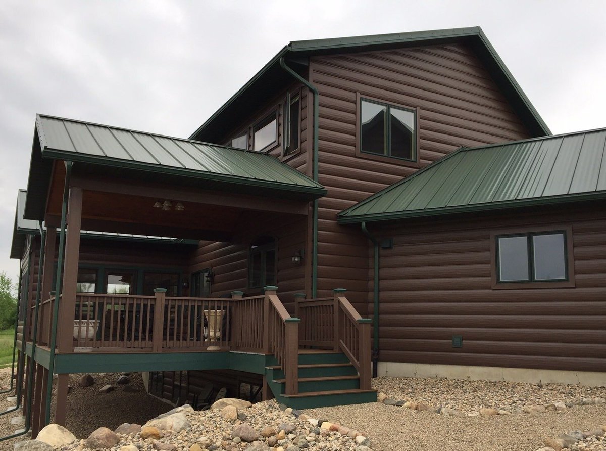 Looks like a log cabin, but it is a steel siding.  

Kind of the best of both worlds.  Think something like this might interest you?