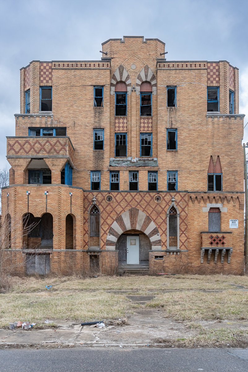 An abandoned early-20th Century apartment building in Detroit, Michigan; Moorish Revival/Exotic Revival with Gothic Revival influences, architecturally. A masterpiece.