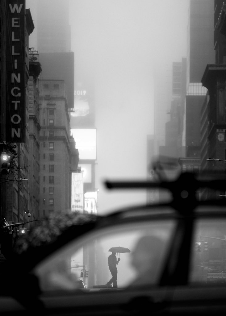 I was shooting low with the Leica SL and 90-280mm, trying to capture people with umbrellas against the NYC fog and light from 42nd Street. Most shots felt cliché, but then... this one happened. A passing car perfectly framed my subject. You can't plan moments like this!