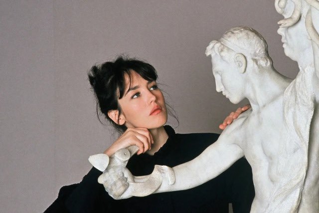 Isabelle Adjani looking at a sculpture “Perseus and the Gorgon” by Camille Claudel.