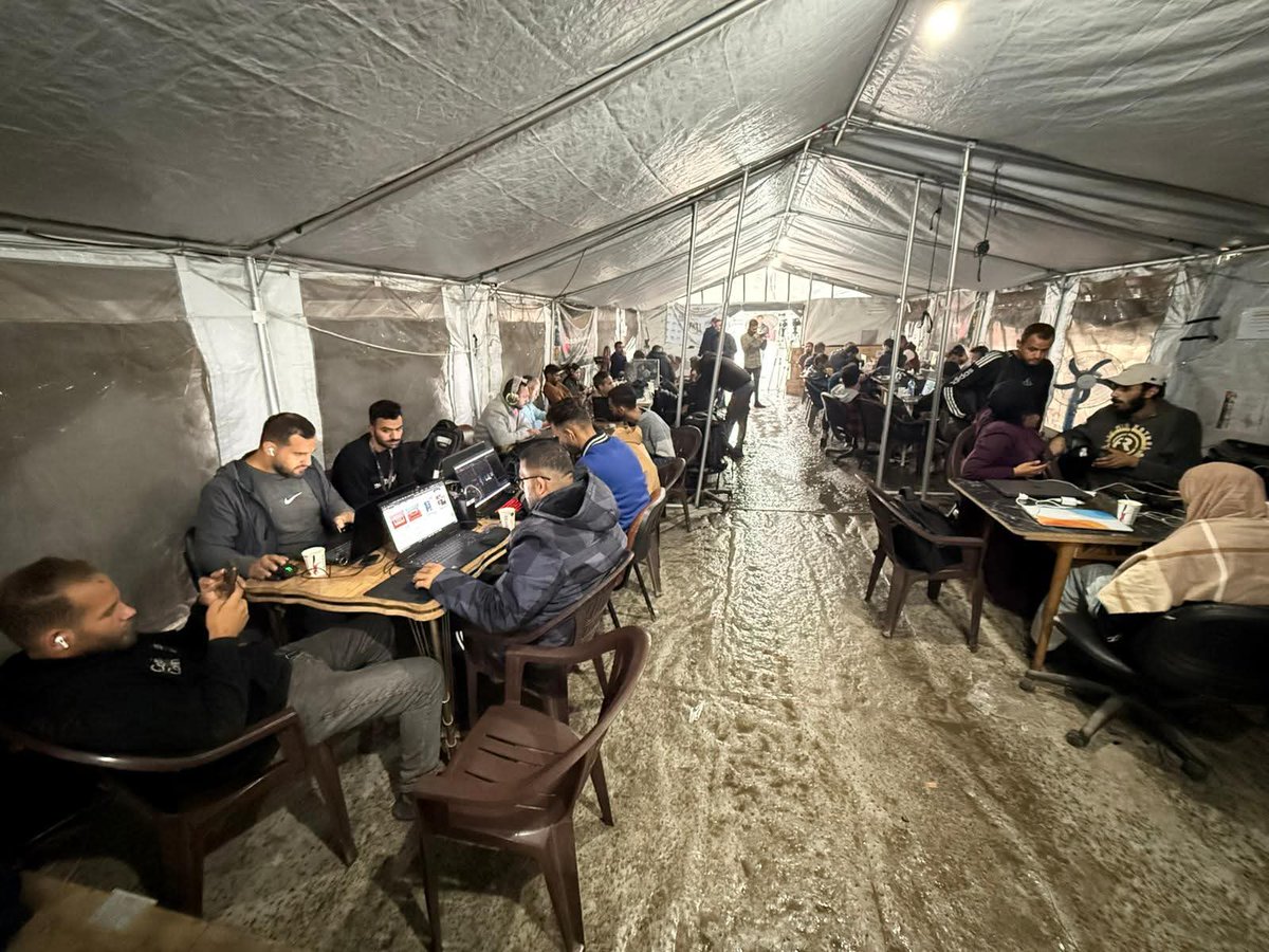 PalPress24's tweet image. Amid the rainy weather in the Gaza Strip, journalists continue their work from inside the Media Solidarity Center in Gaza City, which is affiliated with the Palestinian Journalists’ Syndicate.