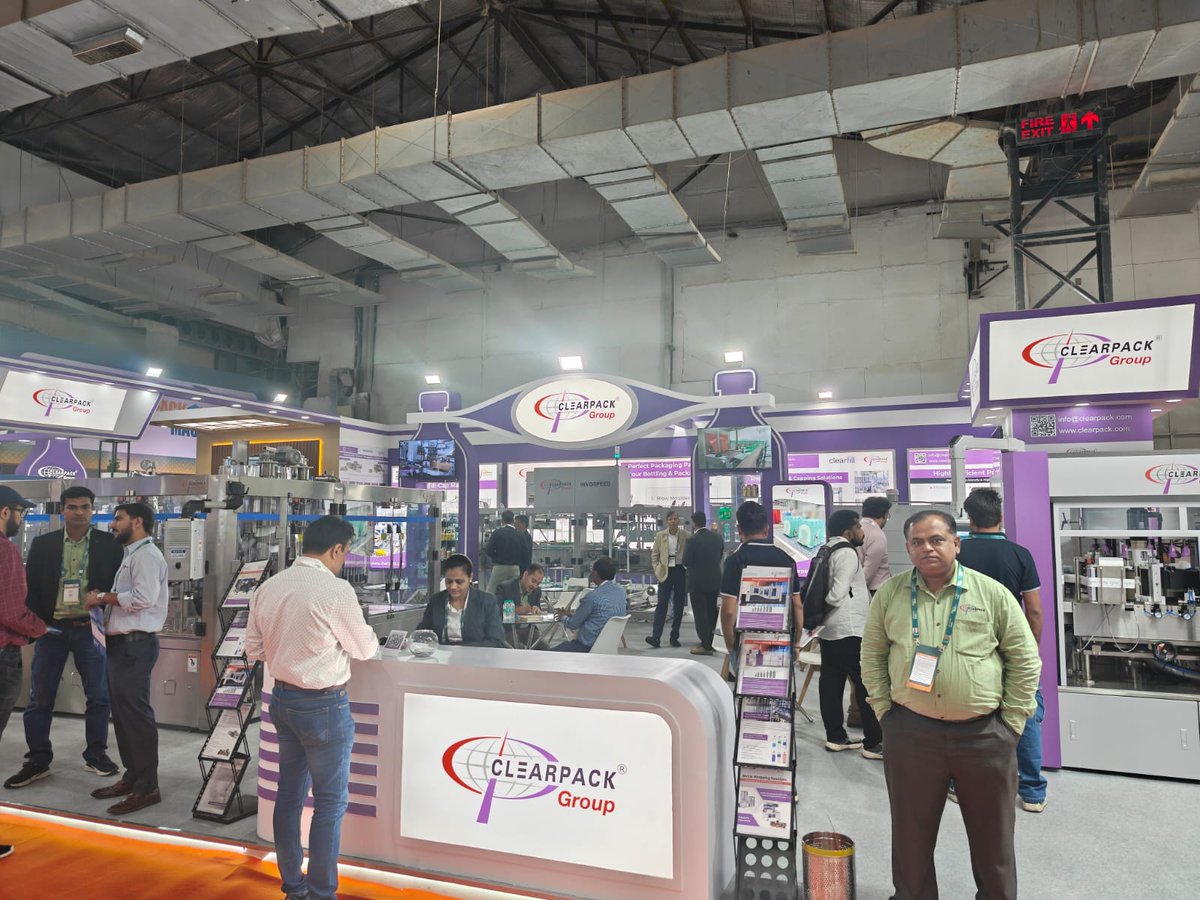 WhatPackaging's tweet image. Clearpack Group demoed its printed shrink-pack systems at #PackMachAsia Expo 2025 and @DrinkTechnology India, highlighting the shift from transparent film to registration-based printed wraps. The team also announced plans to launch its own blow-moulding machine next year.